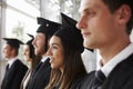 Happy graduates in mortars and gowns, head and shoulders Royalty Free Stock Photo