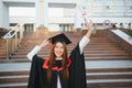 Happy graduation day for a young woman very beautiful with graduation cap smile large in front of the Camera posing Royalty Free Stock Photo