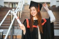 Happy graduation day for a young woman very beautiful with graduation cap smile large in front of the Camera posing Royalty Free Stock Photo