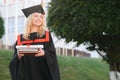 Happy graduation day for a young woman very beautiful with graduation cap smile large, while holding her diploma Royalty Free Stock Photo