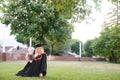 Happy graduation day for a young woman very beautiful with graduation cap smile large, while holding her diploma Royalty Free Stock Photo