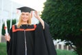 Happy graduation day for a young woman very beautiful with graduation cap smile large, while holding her diploma Royalty Free Stock Photo