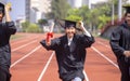 Happy graduation students  holding diploma and running on the stadium at school Royalty Free Stock Photo