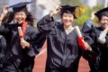 Happy graduation students  holding diploma and running on the stadium at school Royalty Free Stock Photo