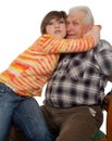 Happy grandchild hugs a happy grandad