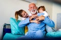 Happy grandchildren visiting grandfather at hospital ward. Support, family and healthcare concept. Royalty Free Stock Photo