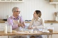Happy granddad and granddaughter enjoy cooking time together in kitchen Royalty Free Stock Photo