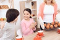 Happy granddaughter and grandson are fun because grandmother baked cupcakes. Royalty Free Stock Photo