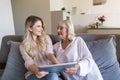 Happy granddaughter and her grandmother using tablet computer Royalty Free Stock Photo