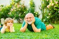 Happy grandfather and child grandson laugh and have fun together in summer in nature. Happy man family concept laugh and