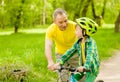 Happy grandfather teaches his grandson to ride a bike Royalty Free Stock Photo