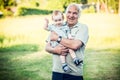 Happy Grandfather with toddler, holding on his arms Royalty Free Stock Photo