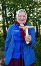 Happy grandma with a big fly agaric Royalty Free Stock Photo