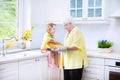 Happy grandmother and girl baking pie in white kitchen Royalty Free Stock Photo