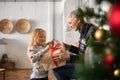 Grandmother giving xmas present to granddaughter Royalty Free Stock Photo