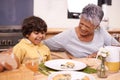 Happy grandmother, grandchild and food with family for thanksgiving, dinner or meal together at home. Grandma and little Royalty Free Stock Photo