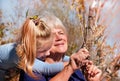 Happy grandmother with granddaughter together outdoors. Grandchild hugs beloved grandmother, happy autumn or spring time