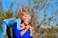 Happy grandmother with granddaughter together outdoors. Grandchild hugs beloved grandmother, happy autumn or spring time