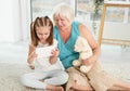 Happy grandmother with granddaughter using tablet Royalty Free Stock Photo