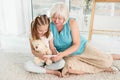 Happy grandmother with granddaughter using tablet Royalty Free Stock Photo