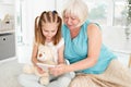 Happy grandmother with granddaughter using tablet Royalty Free Stock Photo