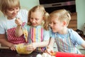 Happy grandmother with her grandchildren having fun during baking muffins and cookies Royalty Free Stock Photo