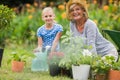 Happy grandmother with her granddaughter gardening Royalty Free Stock Photo