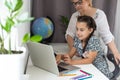 Happy grandmother and her granddaughter having video chat via laptop together at home Royalty Free Stock Photo