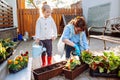 Happy grandmother with her little granddaughter gardening in a backyard. Different generation. Grandmawith and granddaughter Royalty Free Stock Photo