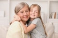 Happy grandmother hugging her granddaughter at home Royalty Free Stock Photo