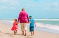 Happy grandmother with kids- little boy and girl- at beach Royalty Free Stock Photo