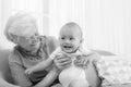 Happy grandmother with little baby at home. Black and white photography Royalty Free Stock Photo