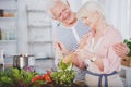 Happy grandmother mixing salad Royalty Free Stock Photo