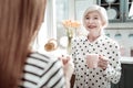 Cheerful senior woman smiling while standing with tea and talking Royalty Free Stock Photo