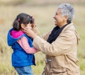 Happy grandmother, young girl and nature walk on farm with senior woman in the countryside. Outdoor field, grass and Royalty Free Stock Photo