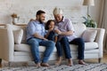 Happy grandpa, father and kid making video call on smartphone Royalty Free Stock Photo