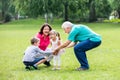 Happy Grandparent And Grandchildren In Park