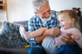 Grandparents playing and having fun with their granddaughter Royalty Free Stock Photo