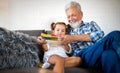 Grandparents playing and having fun with their granddaughter Royalty Free Stock Photo