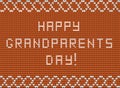 Happy grandparents day white knitted fabric script inscription on orange knitting background with wavy ornament.