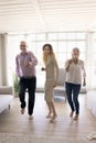 Happy grandparents and excited teenager girl dancing together, having fun Royalty Free Stock Photo