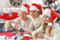 Happy grandparents with grandchild preparing for Christmas together