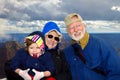 Happy Grandparents Hold Granddaughter at the Grand Canyon