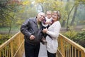 Happy grandparents with little baby granddaughter in beautiful autumn park Royalty Free Stock Photo