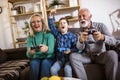 Grandparents playing video games with their grandson