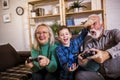 Grandparents playing video games with their grandson Royalty Free Stock Photo