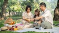 A happy grandparents are telling a fairytale to their lovely granddaughter while picnicking together Royalty Free Stock Photo