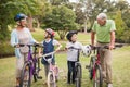 Happy grandparents with their grandchildren on their bike Royalty Free Stock Photo