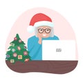 Happy granny with Christmas hat looking at laptop. Old woman with glasses speaking online. Holiday communication with family.