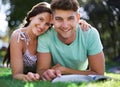 Happy, grass and portrait of couple with books for reading, learning and studying together outdoors. University, college Royalty Free Stock Photo